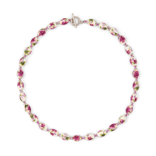 A lovely necklace with ceramic beads featuring romantic floral accents.